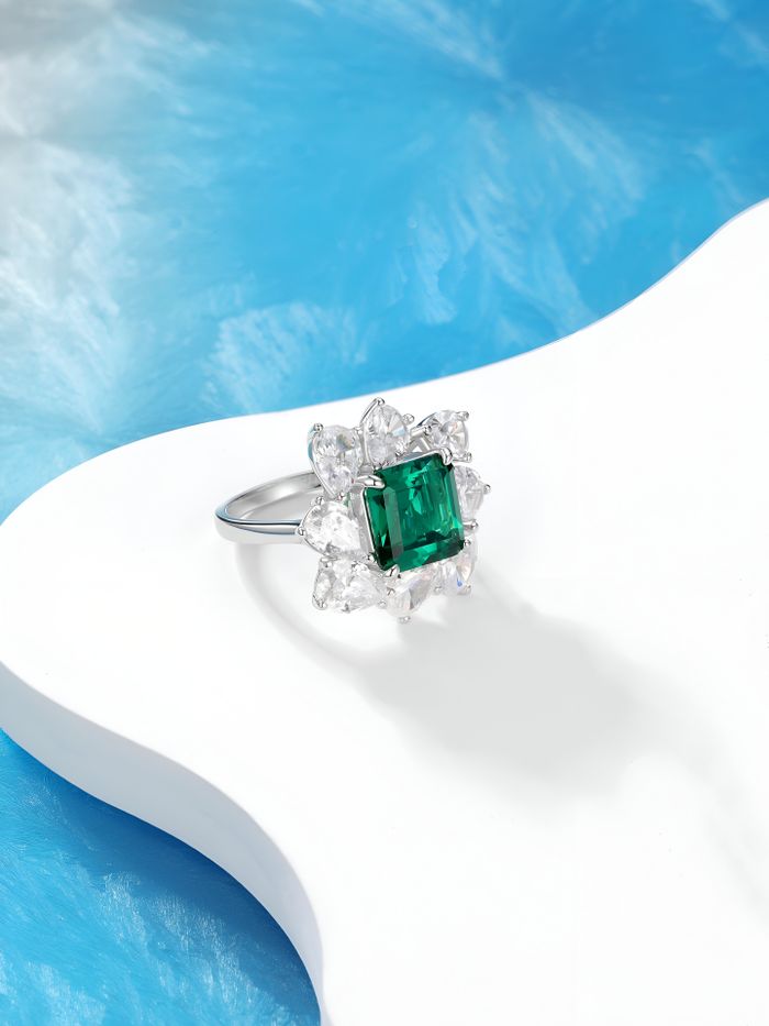 Services Elegant emerald-cut ring with diamond accents, showcasing luxury in a modern design.